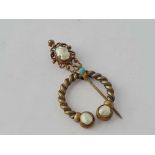 A early 20th century silver gilt pearl and turquoise cloak pin
