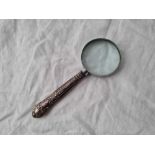 A Magnifying glass with silver handle