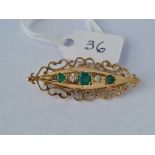 A emerald and diamond brooch in fancy gold design frame 3.4 gms