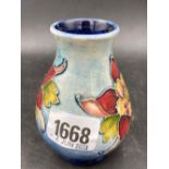 A small Moorcroft vase painted with flowering plant, 4" high (unmarked)