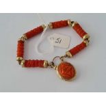 A VICTORIAN CARVED CORAL AND GOLD BRACELET WITH PADLOCK