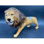 A Beswick figure of a prowling Lion, 9" long