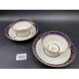 A pair of Worcester tea bowls and saucers with fluted decoration