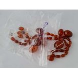 A string of amber beads which need re-stringing 69 gms