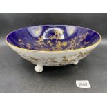 A Coalport bowl on three scroll feet with blue and gilt decoration