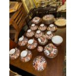 An extensive Crown Derby tea and coffee service painted in brick red and gilt of 11 coffee cups,