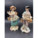 A pair of Sitzendorf figures of man and lady with bird cages, 8" high