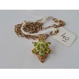 A floral peridot set 9ct pendant on 9ct chain 5.3g inc