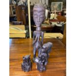 Three more carved African figures, the largest 22" high
