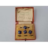 A boxed set of silver and enamel brooch and matching studs
