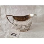An oval half fluted cream jug, London 1919, 72g
