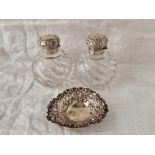 A pair of circular silver top scent bottles (AF) and a heart shaped dish, Birmingham 1898