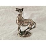 A good silver frolicking horse, 4.5" high, marked on base with import mark by JP, 613g