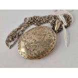 A oval engraved silver locket on chain 24 inch