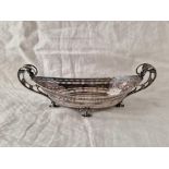 An attractive boat shaped dish with scroll handles, pierced sides, 10.5" long, Sheffield 1897 by