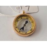 A circular gold compass pendant 6.1 gms