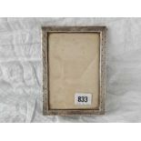 An oblong photo frame with decorated rim, 5.5" tall, London 1913 by WC