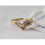 A diamond set ring with 9 baguette and six round cut 18ct gold size K