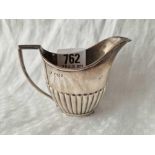 An oval half fluted cream jug on rim foot, Sheffield 1893 by WG, JL, 60g