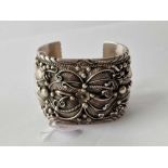 A large stylistic silver bangle 137 gms