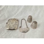 An engraved vesta case, Birmingham 1926, two thimbles and a wine label
