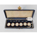A cased set of six gold and mother of pearl buttons