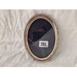 An oval photo frame with gadroon border, 6.5” high, Sheffield 1996