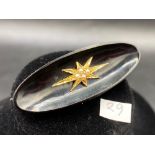 A Victorian pearl star high carat on oval onyx brooch reverse with white metal makers mark
