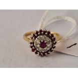 A DIAMOND AND RUBY CLUSTER RING, 18ct size N, 5 g