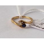 A sapphire and diamond cross over ring 18ct gold size M 2.6 gms