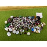 A mixed lot of assorted gem stones pearl opal peridot garnet and paste