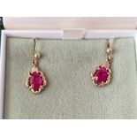 A pair of boxed ruby drop earrings 9ct 2.4 gms