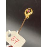 A fancy scrolled ruby and pearl stick pin 15ct gold screw top