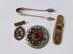 A very ornate gilt and enamel pen knife with trade mark for BAYER together with sugar tongs