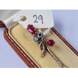 A boxed gold rose diamond and garnet stick pin 3.1 gms