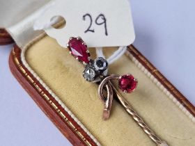 A boxed gold rose diamond and garnet stick pin 3.1 gms