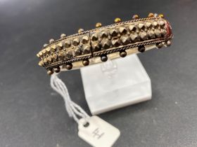 A unusual antique silver studded bangle