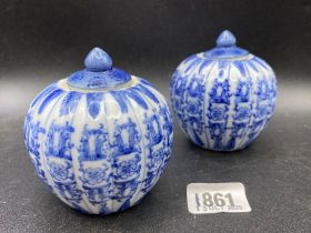 A pair of blue and white jars and covers 3" high