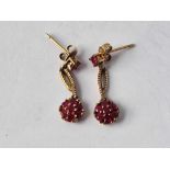 A pair of ruby daisy head earrings 9ct 1.7 gms