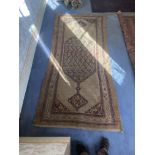 An Antique oriental hall carpet with pole medallion 10ft x 4ft 3" with Liberty & Co, label on