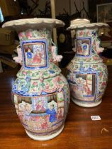 A good pair of 19th Century Canton vases with panels of figures 13 inches high