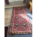 An oriental rug with 2 rows of medallions, 5ft 9" x 4ft 2"