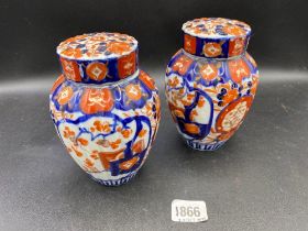 A pair of Imari jars and covers