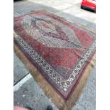 A large Antique red ground carpet with centre medallion, some damage & missing, 18ft x 12ft