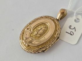 A Victorian oval decorated buckle locket 15ct gold tested 6.5 gms