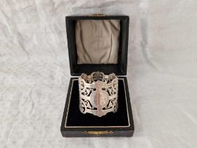 An attractive boxed napkin ring with pierced decoration, London 1902 by GJ, DF?