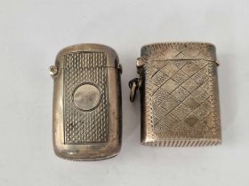 Two vesta cases, one with checkered decoration and stamped cunard line and sterling the other London