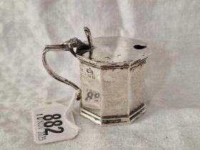 An octagonal mustard pot with shell thumb piece, 2" high, Birmingham 1938 by E & Co, 50g excluding