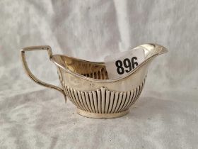 A small oval cream jug, half fluted, Birmingham 1906, 41g