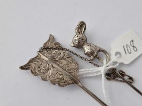 A White Metal Mouse Toped Stick Pin Together With A Silver Arrow Brooch